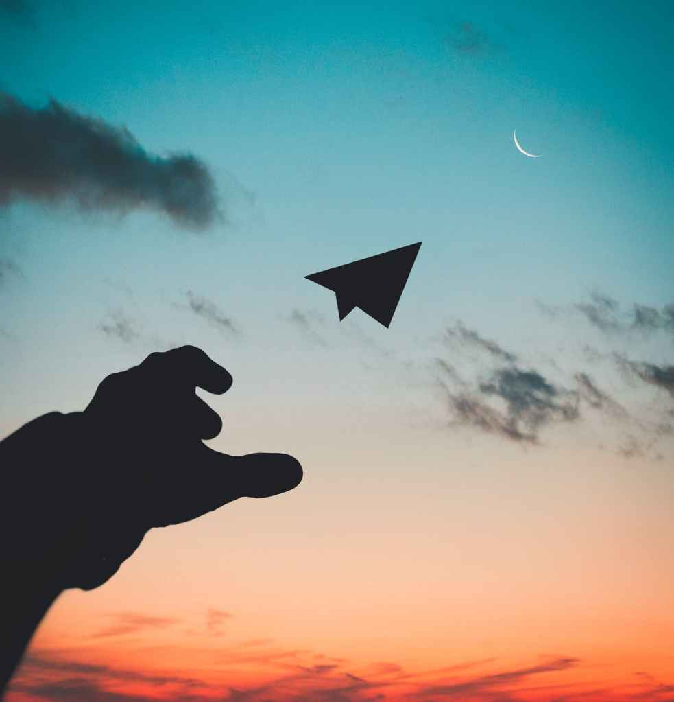 Throwing a paper plane to the moon, wishing for a better life