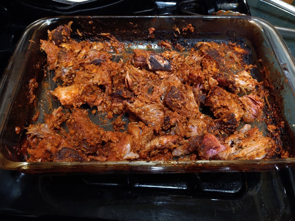 Cooked Jamaican Jerk Pork in pyrex pan