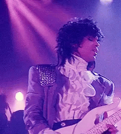 Prince the musician in costume playing guitar