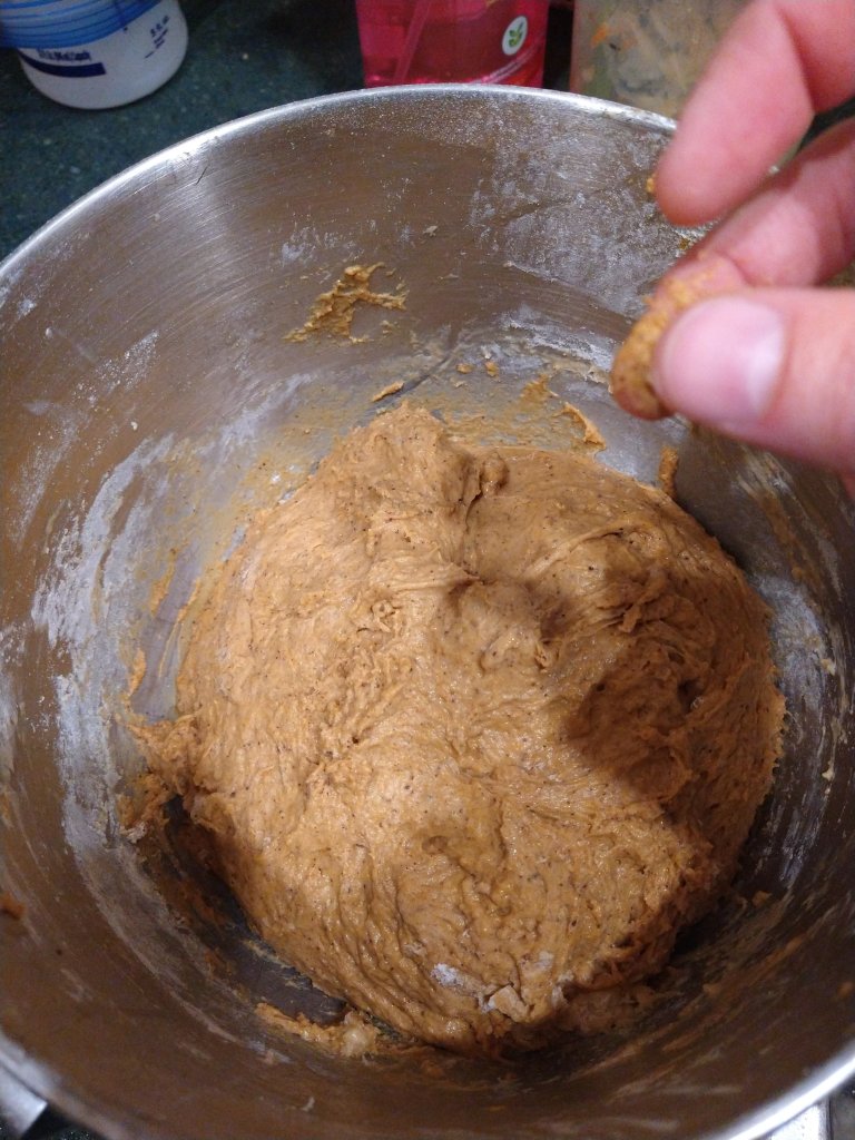 picture of cinnamon roll dough in the bowl before it the rising step.