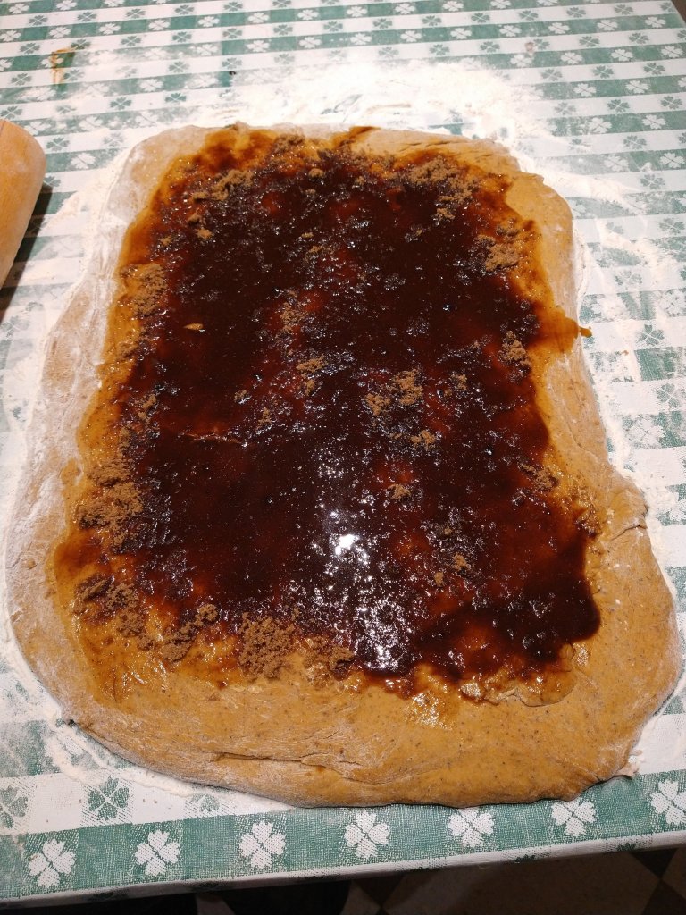 Picture of pumpkin spice filling spread evenly on rolled out dough on a floured table.