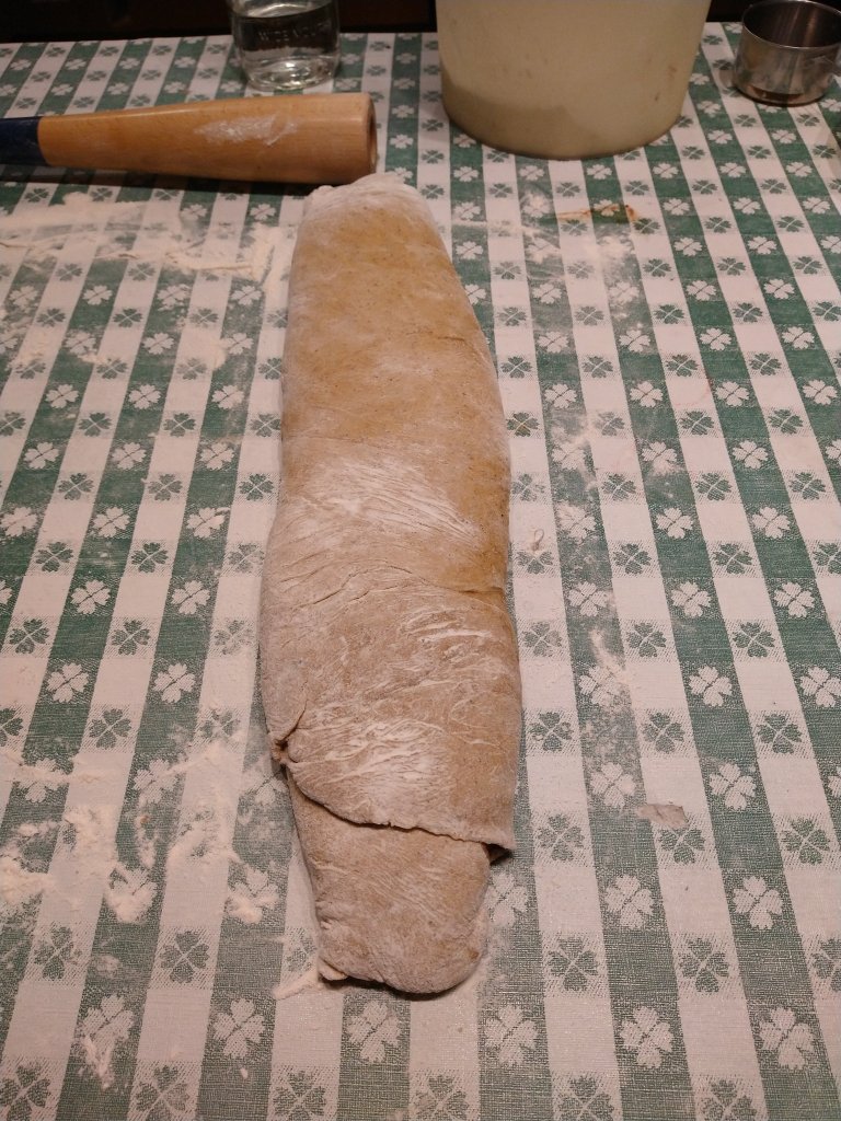 Picture of a rolled up pumpkin spice cinnamon roll roll before it is divided.