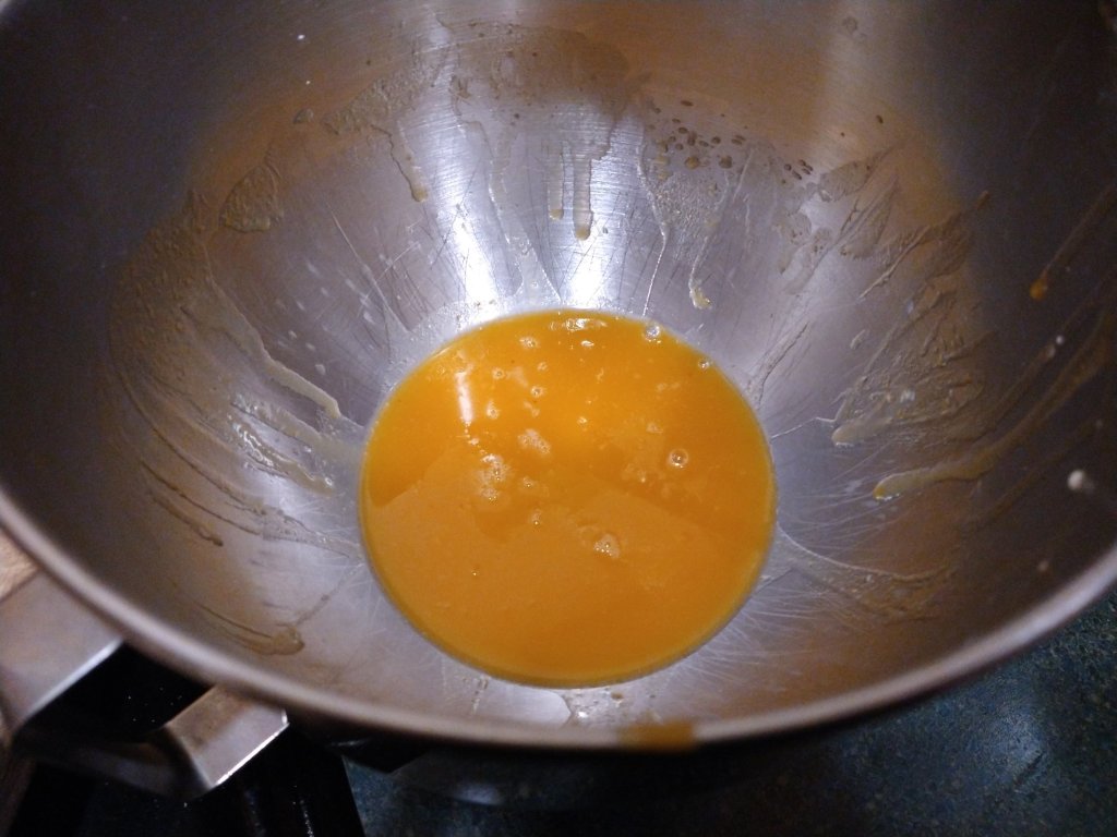 The pumpkin glaze for the rolls in a kitchen aid mixer bowl.