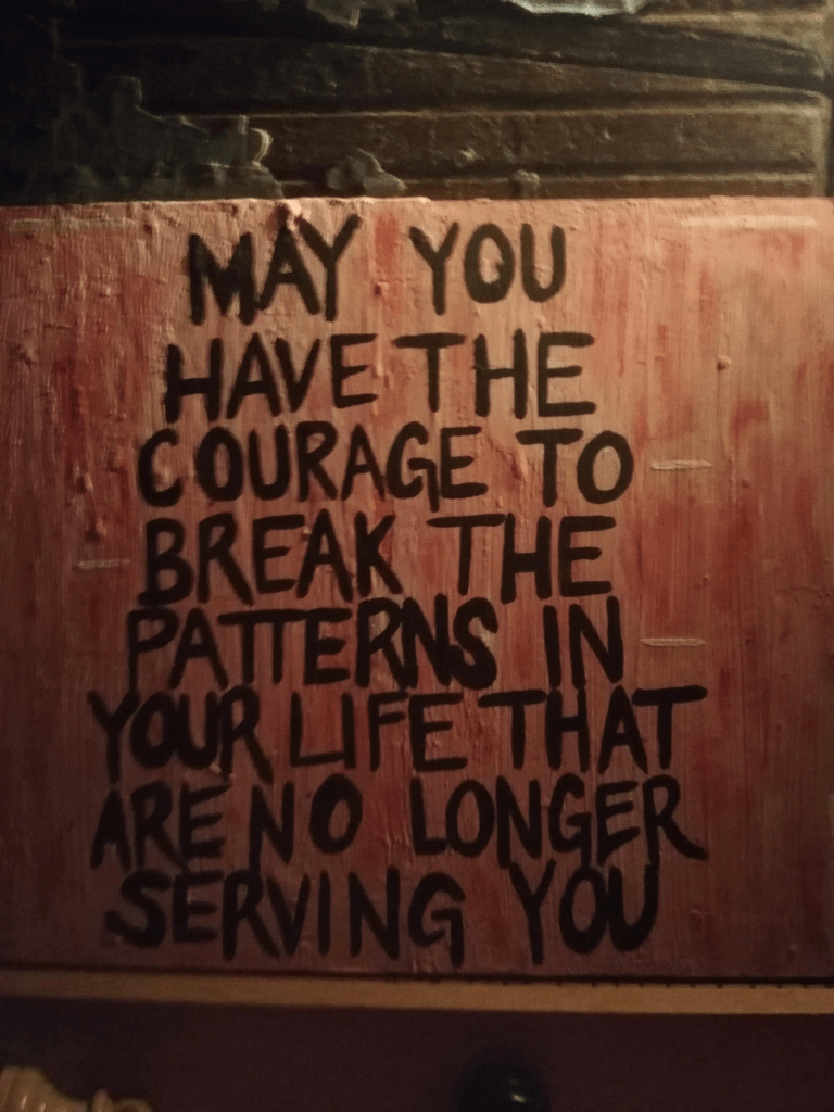 Black text on painted wood: May you have the courage to break the patterns in your life that no longer serve you. From Reddit.